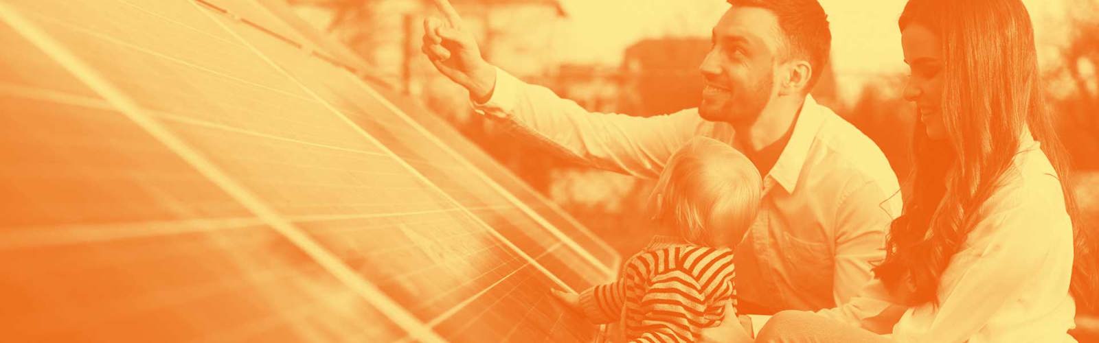 Young family with a baby looking at solar panels