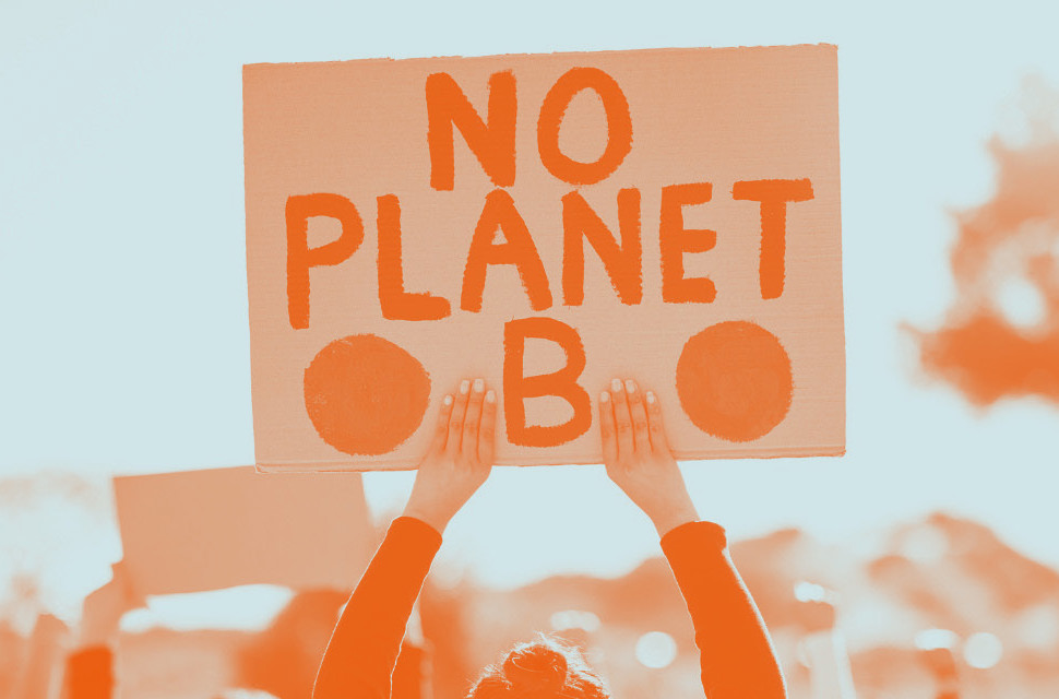 Person holding a sign that says 'No Planet B'