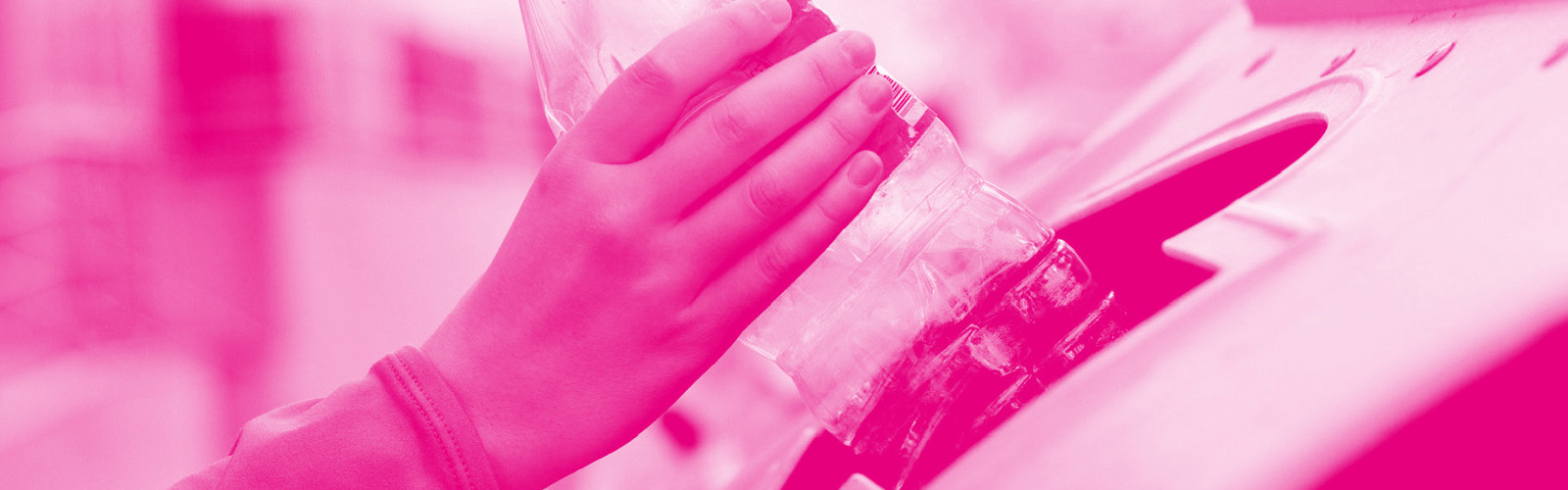 Woman's hand recycling a plastic bottle to save the environment